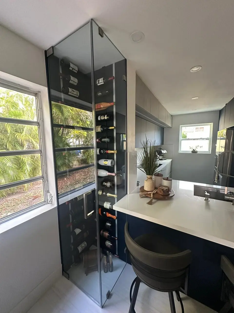 Kitchen bar with built-in wine rack feature and white countertops